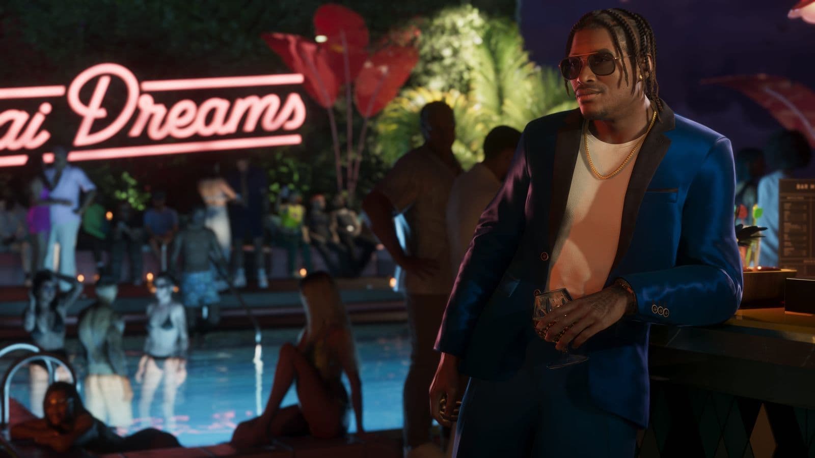 Dre’Quan Priest in a blue suit at a poolside party at night
