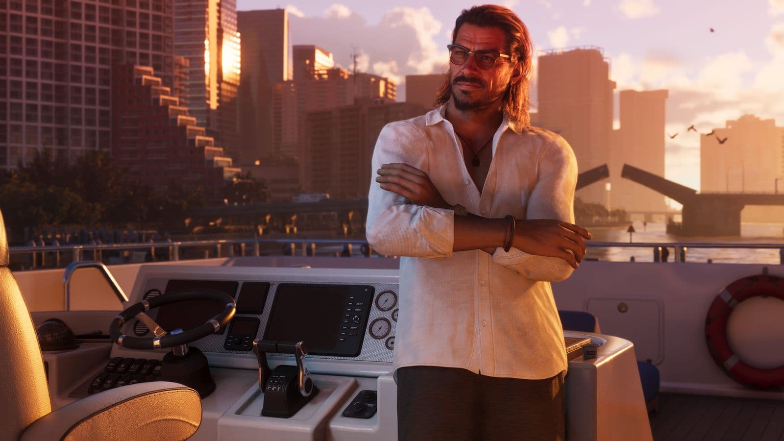 Raul Bautista standing on a boat with his arms crossed, the city behind him at sunset